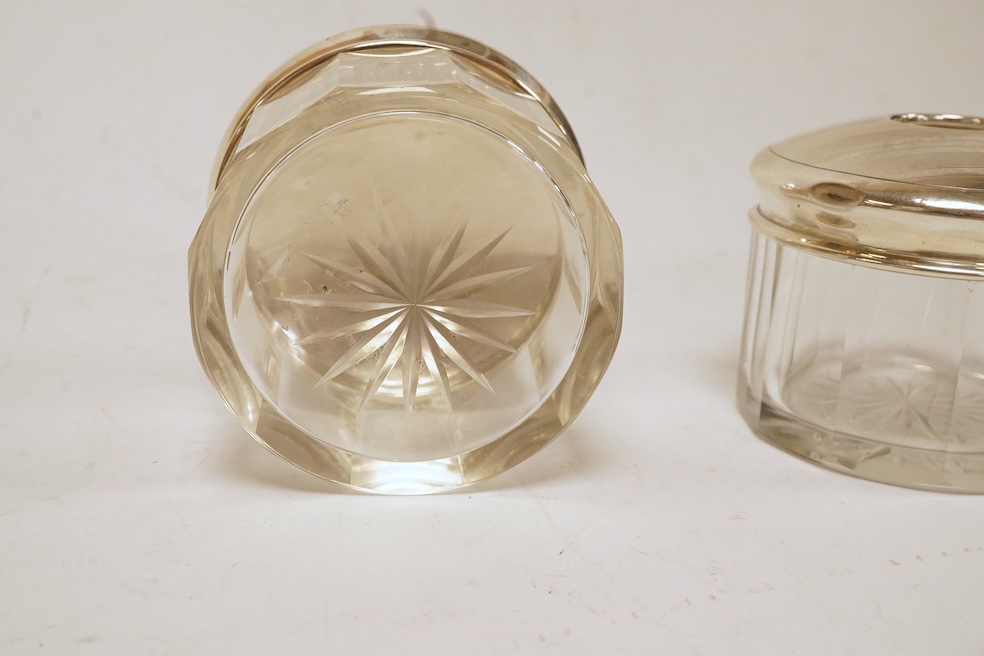 Six assorted silver lidded glass toilet jars including long rectangular, Birmingham, 1904, 22.9cm, together with a silver mounted hand mirror. Condition - poor